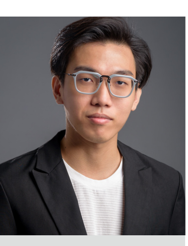 Tran Binh Van wearing glasses and a dark blazer